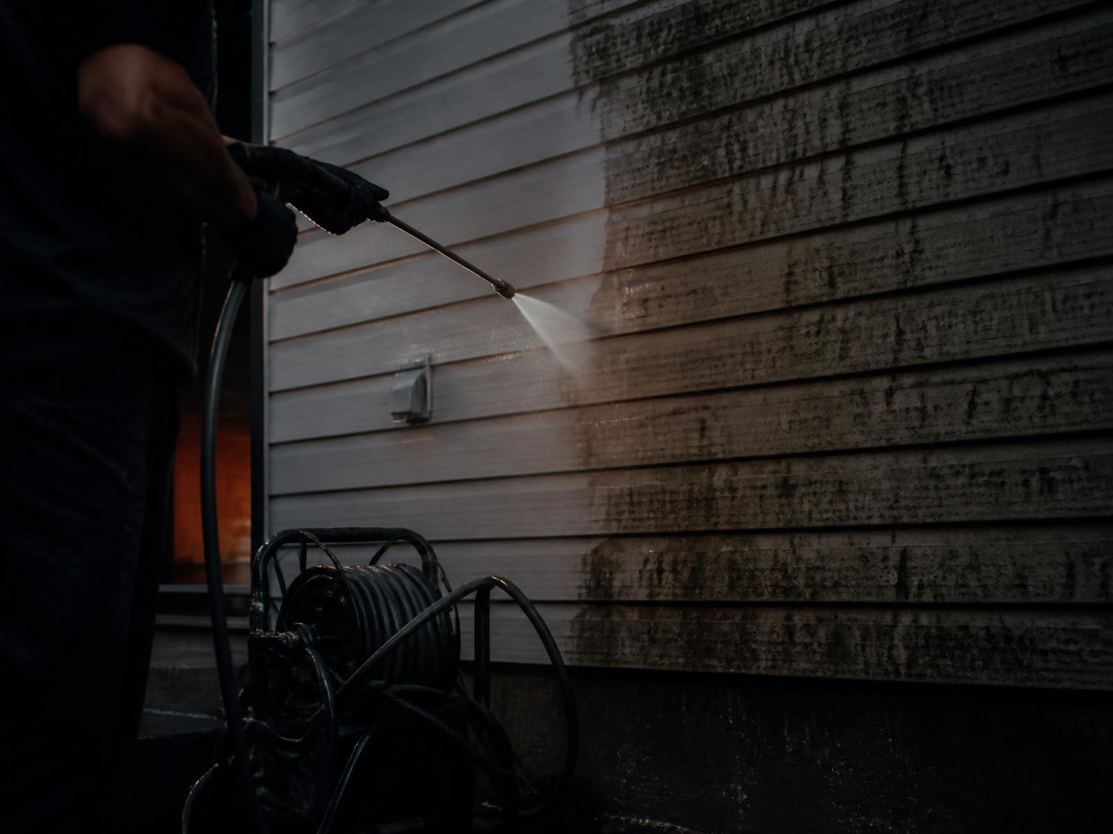 Soft washing spray cleaning house siding